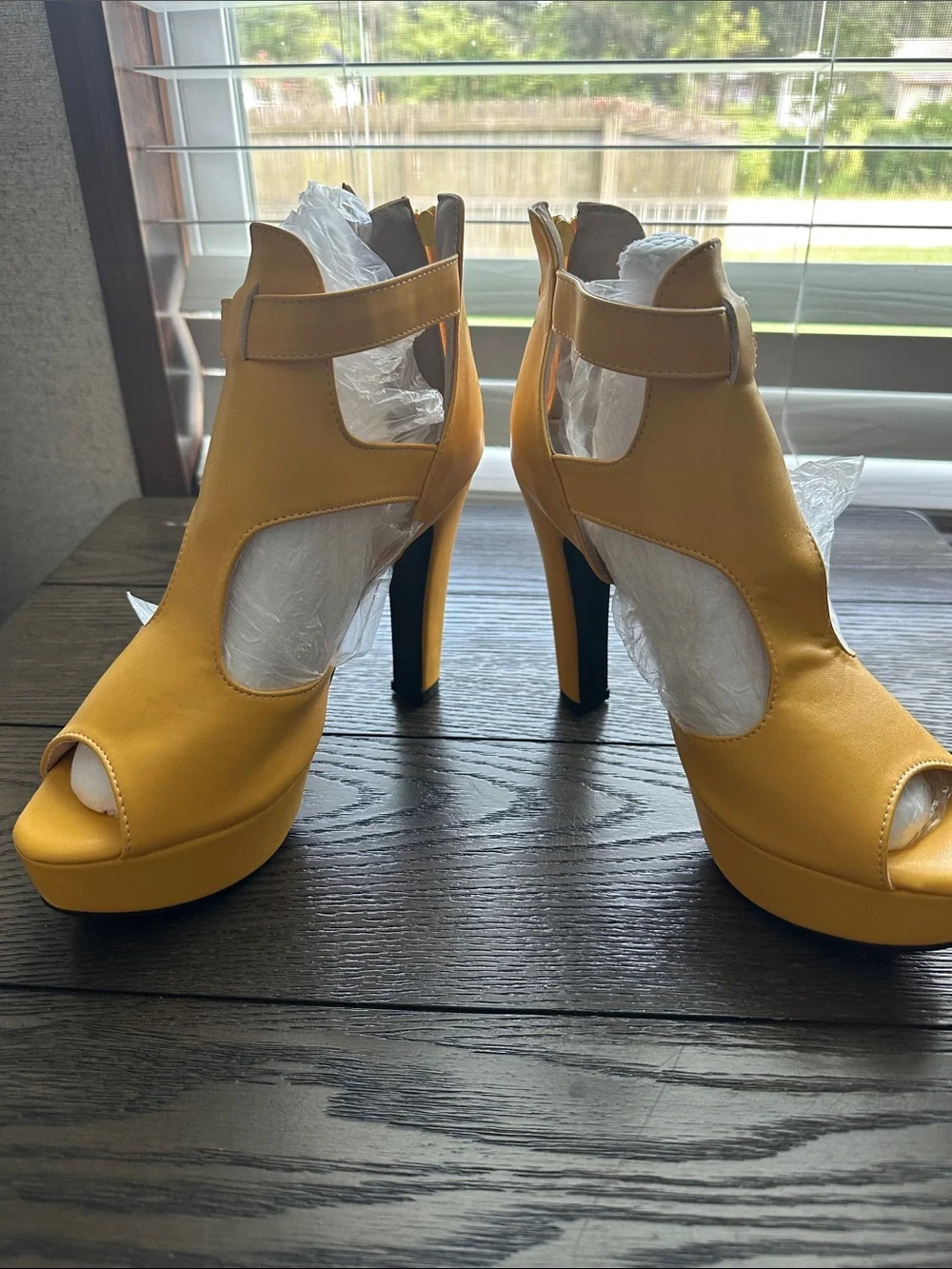 Fereshte mustard yellow peep toe high heel ankle booties.